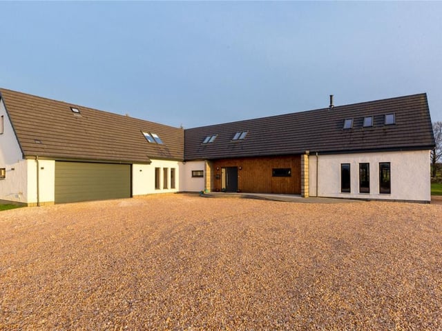 Front of property with garage and parking area.