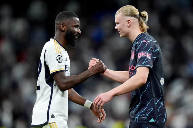 Antonio Ruediger of Real Madrid and Erling Haaland of Manchester City shake hands after the draw in the Spanish capital.