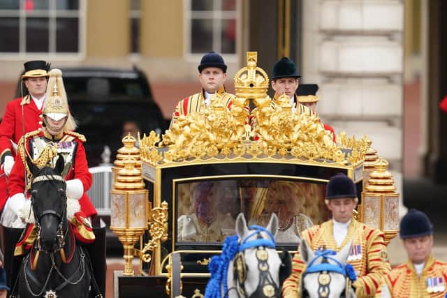 King Charles III and Queen Camilla are carried in the Diamond Jubilee State Coach in The King's Procession from Buckingham Palace to their coronation ceremony. Picture: Owen Humphreys/PA Wire