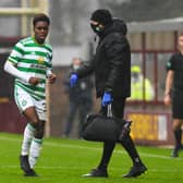 Celtic's Jeremie Frimpong limps to the sidelines after being hurt in a challenge by Devante Cole of Motherwell. Picture: SNS