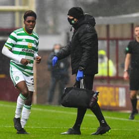 Celtic's Jeremie Frimpong limps to the sidelines after being hurt in a challenge by Devante Cole of Motherwell. Picture: SNS