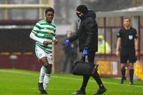 Celtic's Jeremie Frimpong limps to the sidelines after being hurt in a challenge by Devante Cole of Motherwell. Picture: SNS
