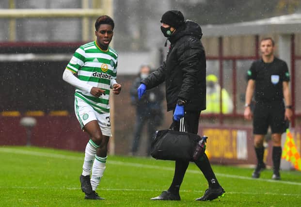 Celtic's Jeremie Frimpong limps to the sidelines after being hurt in a challenge by Devante Cole of Motherwell. Picture: SNS