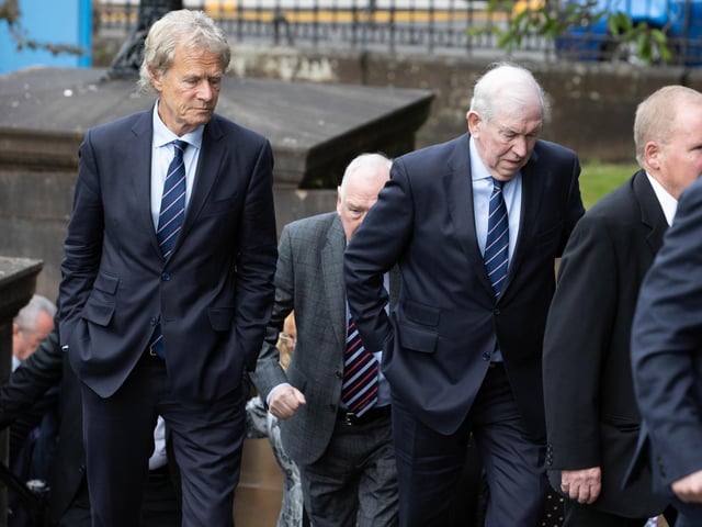 Former chairman Alastair Johnston (L) and club legend John Greig arrive at the funeral of Rangers kitman Jimmy Bell