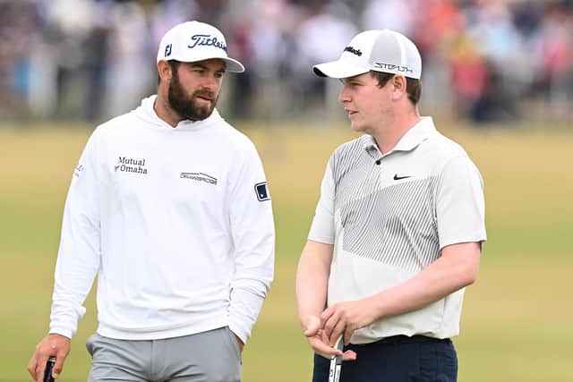 Leader Cameron Young chats with playing partner Bob MacIntyre on the 17th green during the first round at the Old Course. Picture: Ian Rutherford.