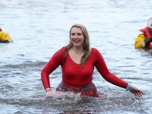 People take part in the Loony Dook New Year's Day dip in the Firth of Forth at South Queensferry