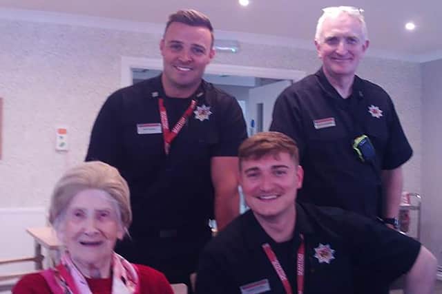 Resident Margaret Nash at HC-One Scotland’s Hatton Lea Care Home with Firemen from Bellshill Fire Service