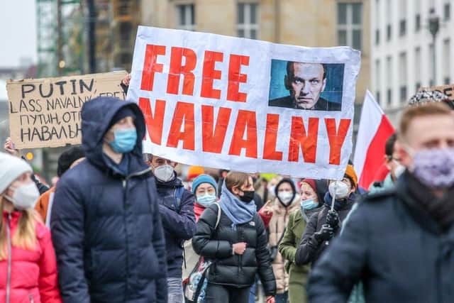 Protesters hold a banner reading "FREE NAVALNY". (Pic: Getty Images)