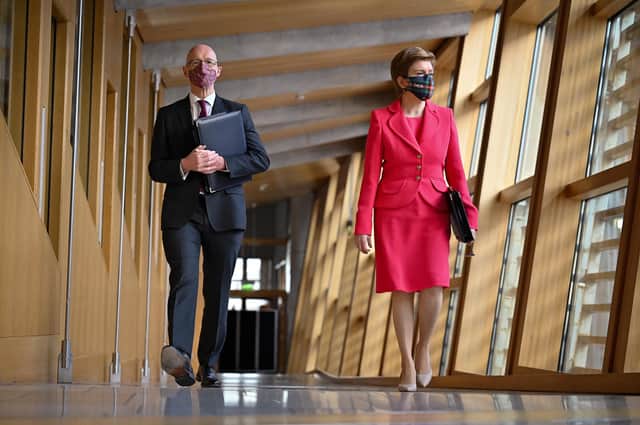Scotland's First Minister Nicola Sturgeon and John Swinney Deputy First Minister of Scotland arrive for First Minster's Questions at the Scottish Parliament in Holyrood, Edinburgh. Picture date: Thursday December 16, 2021.