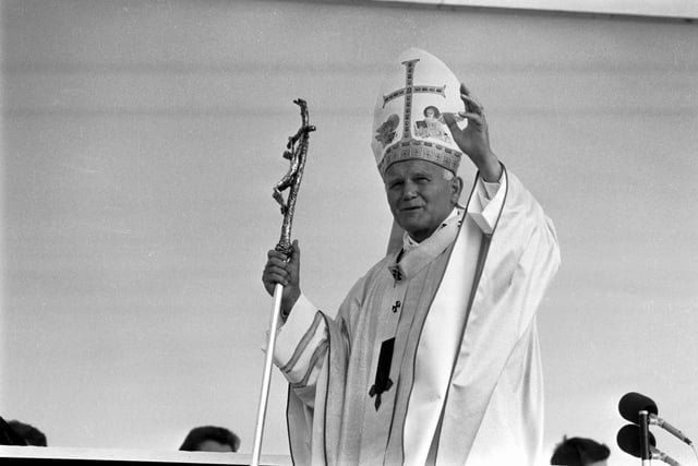 Pope John Paul II waves to the crowds of supporters at Bellahouston Park, in Glasgow.
