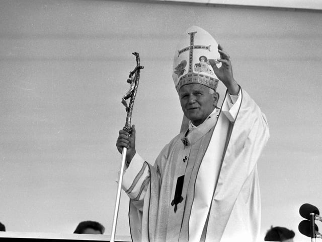 Pope John Paul II waves to the crowds of supporters at Bellahouston Park, in Glasgow.