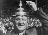 The Doc tips his makeshift hat - the FA Cup final lid - to his exciting Manchester United team after their 1977 Wembley triumph.