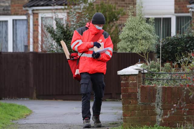 A Royal Mail delivery worker wearing a mask. Picture: PA