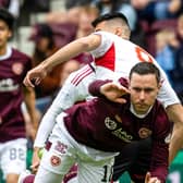 Hearts defeated Aberdeen 2-1 to keep the race for third place alive.
