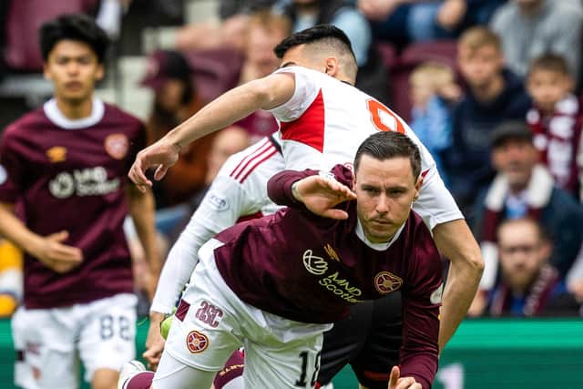 Hearts defeated Aberdeen 2-1 to keep the race for third place alive.