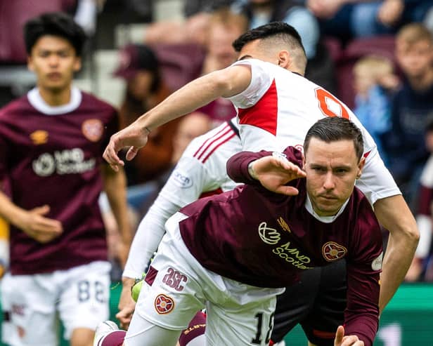 Hearts defeated Aberdeen 2-1 to keep the race for third place alive.