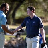 World No 1 Dustin Johnson shakes hands with Bob MacIntyreafter a tie in their match during the World Golf Championships-Dell Technologies Match Play at Austin Country Club in Texas at the end of March. Picture: Steve Dykes/Getty Images.