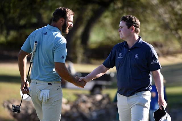 World No 1 Dustin Johnson shakes hands with Bob MacIntyreafter a tie in their match during the World Golf Championships-Dell Technologies Match Play at Austin Country Club in Texas at the end of March. Picture: Steve Dykes/Getty Images.