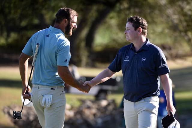 World No 1 Dustin Johnson shakes hands with Bob MacIntyreafter a tie in their match during the World Golf Championships-Dell Technologies Match Play at Austin Country Club in Texas at the end of March. Picture: Steve Dykes/Getty Images.