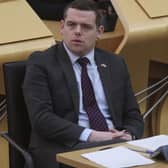 Scottish Conservative leader Douglas Ross listens to First Minister Nicola Sturgeon. Picture: Fraser Bremner/Daily Mail/PA Wire