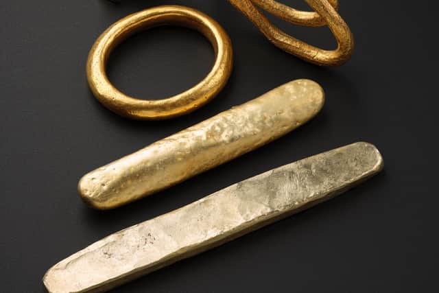 Pieces of Viking gold, some which were found in a wooden box that was tucked between several arm rings. PIC: NMS.