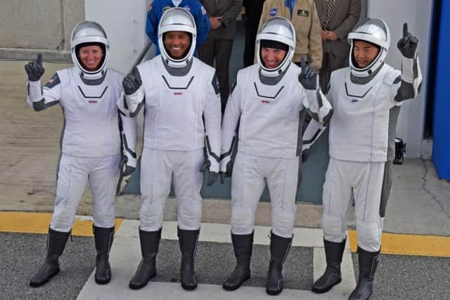 (L-R) NASA astronauts, mission specialist Shannon Walker, vehicle pilot Victor Glover, commander Mike Hopkins, and mission specialist Soichi Noguchi from the Japan Aerospace Exploration Agency (JAXA) (Photo: Red Huber/Getty Images)