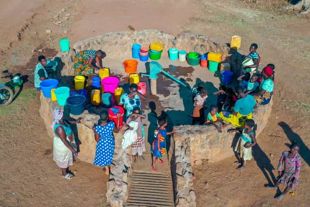 Aerial view of women and children doing the time-consuming task of water collection - filling buckets and waiting for their turn at a borehole on Chisi Island in Malawi. Picture: Dennis Lupenga