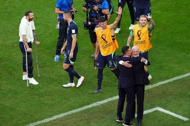 Boyle, pictured far left on crutches, has stayed with the Australian national team to support them at the World Cup.