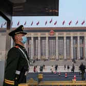 A police officer stands guard over the Great Hall of the People in Beijing, China.