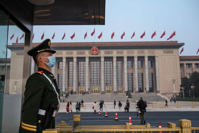 A police officer stands guard over the Great Hall of the People in Beijing, China.