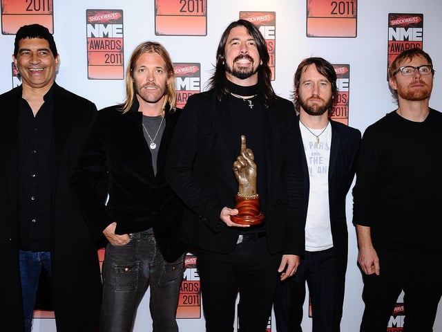 Dave Grohl (centre) with his God Like Genius award and the rest of his band Foo Fighters, at the 2011 NME Awards at the O2 Academy Brixton, London. Taylor Hawkins (second left), drummer of rock group Foo Fighters has died at the age of 50, the band has announced, saying it was "devastated by the untimely loss" and asked for the privacy of his family to be respected.