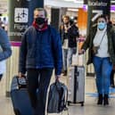 Passengers travel through Edinburgh Airport wearing face masks. Picture: Lisa Ferguson