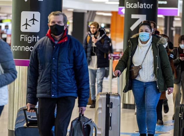 Passengers travel through Edinburgh Airport wearing face masks. Picture: Lisa Ferguson