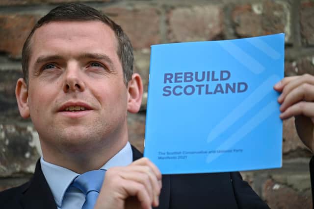 Scottish Conservative party leader Douglas Ross holds a copy of his party's election manifesto (Picture: Jeff J Mitchell/Getty Images)