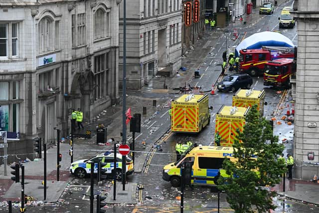 Police officers cover with an inflatable tent, behind a firefighter vehicle, the tents delimiting the scene of an incident in Water Street, on the sidelines of an open-top bus victory parade for Liverpool's Premier League title win, in Liverpool, north-west England on May 26, 2025. A car collided with a number of pedestrians in Liverpool, northern England, on May 26 evening during Liverpool FC's Premier League victory parade, police said. Police said they were contacted shortly after 6pm (1700 GMT) 'following reports of a collision between a car and a number of pedestrians' in the city centre. One man has been arrested, according to the police, who did not say whether there were any casualties. (Photo by Paul ELLIS / AFP) (Photo by PAUL ELLIS/AFP via Getty Images)