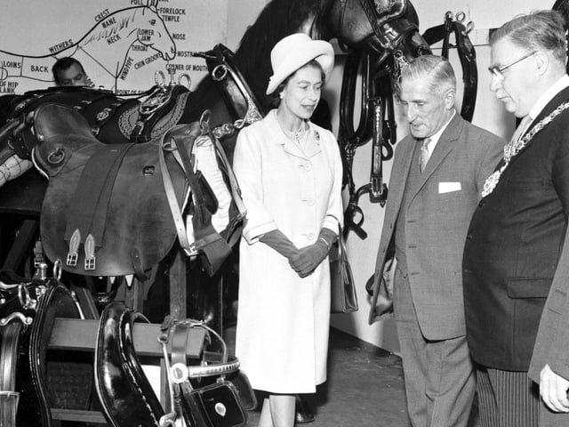 Queen Elizabeth II inspecting bridles, sadles and halters during a visit to St Cuthbert's Transport Department in Edinburgh in June 1966.
