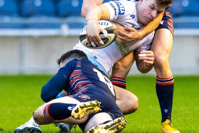 Hamish Watson, top, gets to grips with Glasgow's Huw Jones during Edinburgh's 1872 Cup win on Saturday. Picture: Ross Parker/SNS