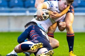 Hamish Watson, top, gets to grips with Glasgow's Huw Jones during Edinburgh's 1872 Cup win on Saturday. Picture: Ross Parker/SNS