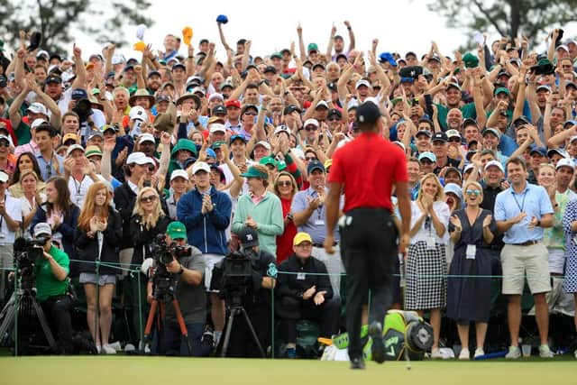 Patrons cheer as Tiger Woods walks off the 18th green after winning the 2019 Masters at Augusta National Golf Club. Picture: Andrew Redington/Getty Images