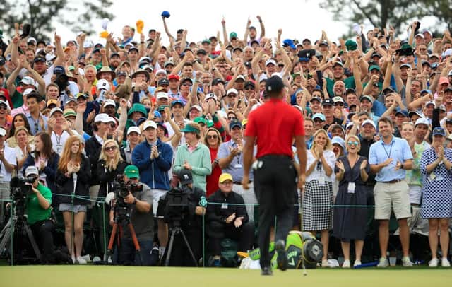 Patrons cheer as Tiger Woods walks off the 18th green after winning the 2019 Masters at Augusta National Golf Club. Picture: Andrew Redington/Getty Images