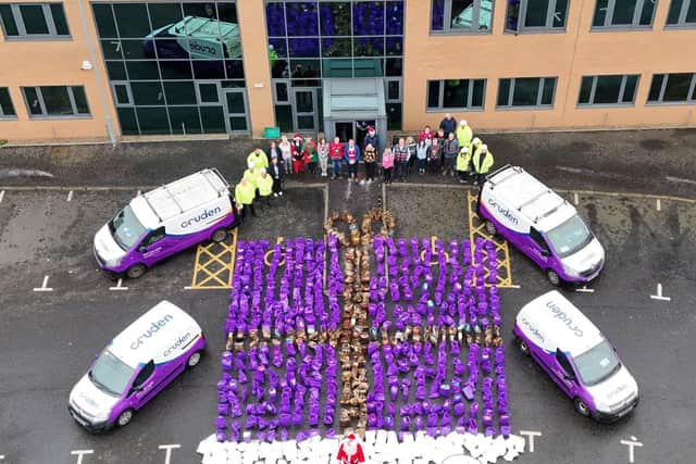 Cruden staff with 6 tonnes of food donations collected in 2024