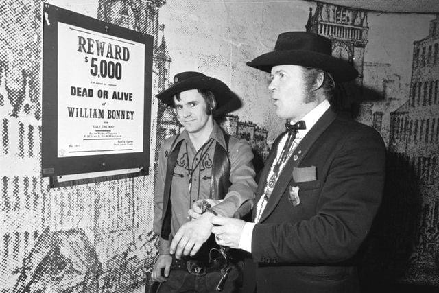 Dressed as cowboys and Western characters Dick Gilmour (as Marshall Dillon) 'arrests' Jim Webb (as Billy the Kid) ina Paisley Road West club, Glasgow, November 1980