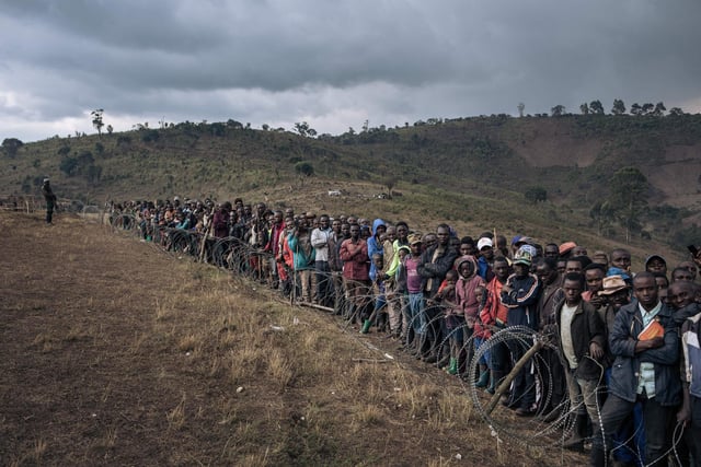 Displaced persons attend a visit by Congolese Defense Minister Aimé Ngoy Mukena