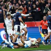 France centre Gael Fickou (bottom) scores the final try to condemn Scotland to a 32-21 defeat in Paris. (Photo by ANNE-CHRISTINE POUJOULAT/AFP via Getty Images)