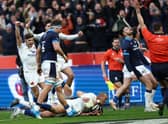 France centre Gael Fickou (bottom) scores the final try to condemn Scotland to a 32-21 defeat in Paris. (Photo by ANNE-CHRISTINE POUJOULAT/AFP via Getty Images)