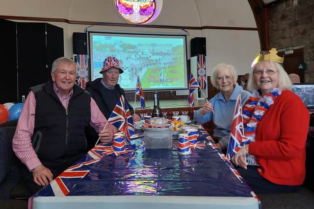 John Summers, 76, (front left) and Raymond Emslie, 73 behind with their wives Margaret Emslie (front right) and Alison Summers, 71. The group of friends are celebrating the coronation at the Albert Hall in Ballater where the coronation is being screened. (pic: Katharine Hay)