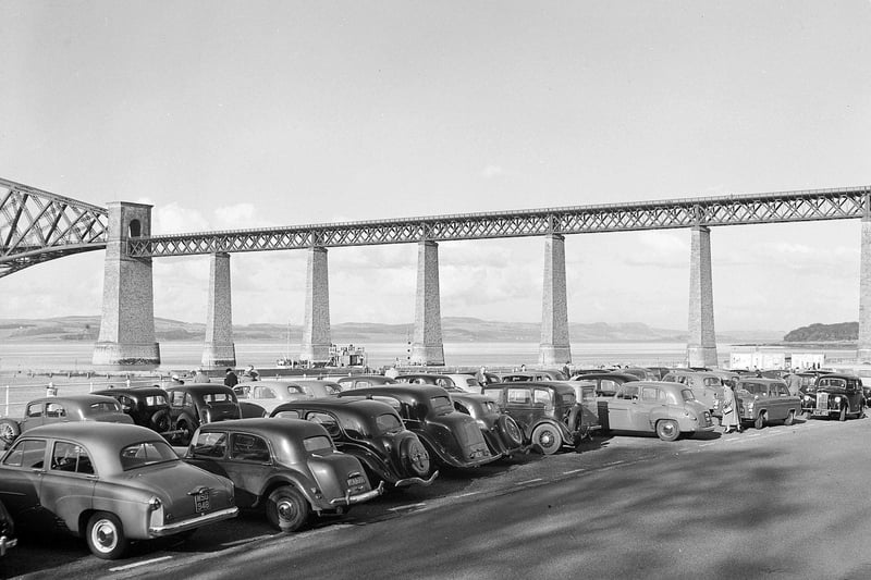 South Queensferry - Cars queue for ferry with the Forth Rail Bridge in background