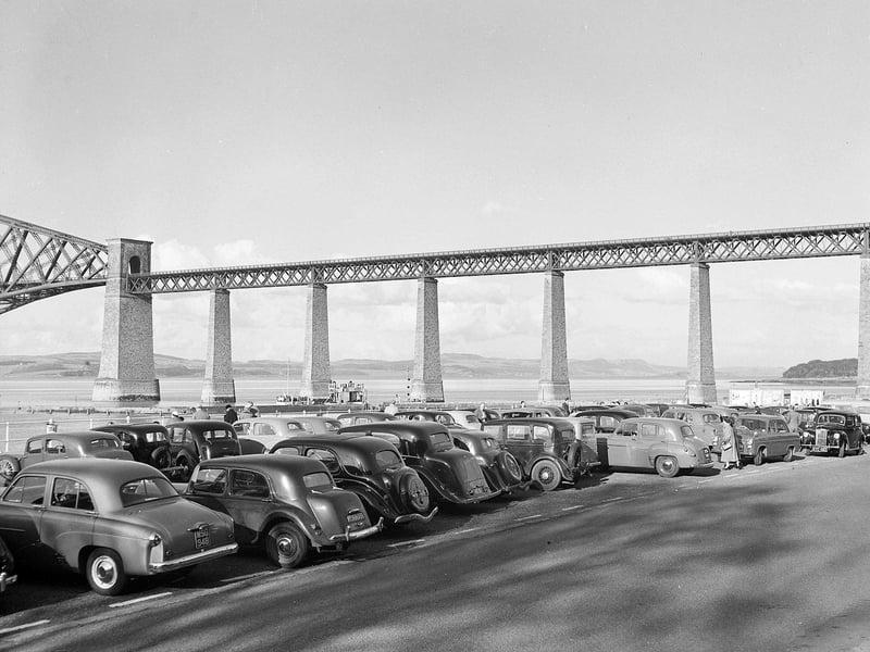 South Queensferry - Cars queue for ferry with the Forth Rail Bridge in background