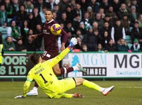 Toby Sibbick lifts the ball over Hibs goalkeeper David Marshall to make it 3-0 to Hearts against Hibs.