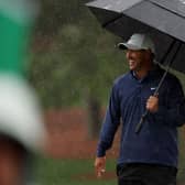 Brooks Koepka shelters under a brolley on a wet day at Augusta National Golf Club. Picture: Patrick Smith/Getty Images.